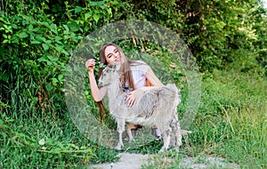 Girl play cute goat. Feeding animal. Protect animals. Veterinarian occupation. Eco farm. Love and care. Animals law