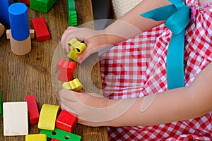 Girl play with educational toy on table in the children's room, childcare center, concept childhood