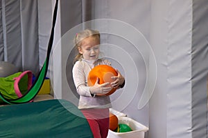 Girl play with heavy ball, concept creative sensory games in the sensory integration