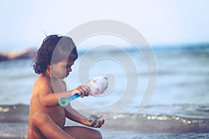 Girl play with shovel in sand