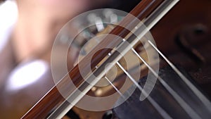 Girl play the violins in a room. Black background