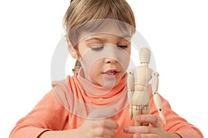 Girl is played by wooden little manikin isolated