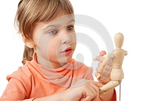 Girl is played by wooden little manikin isolated