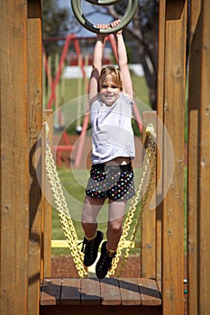 Girl on playground equipment