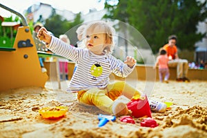 Girl on playground in sandpit