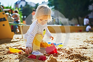 Girl on playground in sandpit