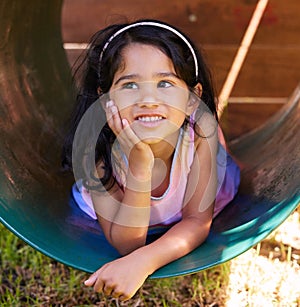 Girl, playground and thinking with fun, youth and child outdoor in a park with idea. Kid, smile and happy on school