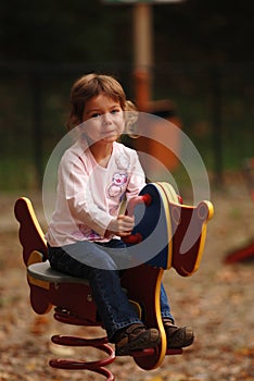 Girl on playground toy
