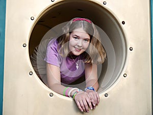Girl in playground tunnel