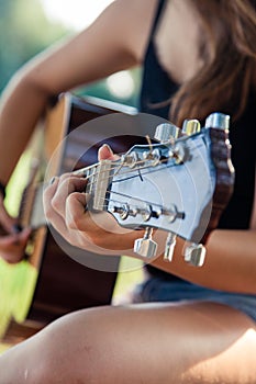 Girl playing an acoustic guitar