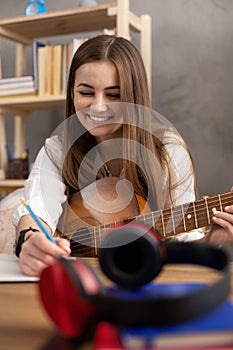 Girl playing acoustic guitar. Musician woman in studio with classic guitar