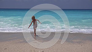 Girl Playing on Beach, Kid Running on Seashore at Sunset, Child Watching Sea Waves on Coastline Shore in Summer, Lefkada Greece