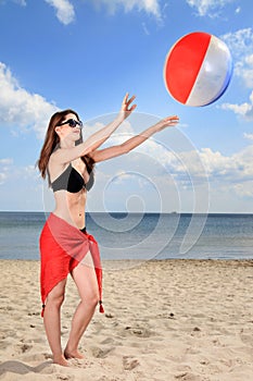 Girl playing beach volleyball.