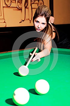 Girl playing billiard