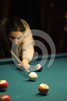 Girl playing billiard