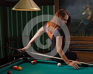 Girl playing billiards