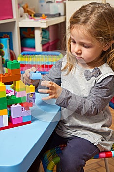 girl is playing with building bricks