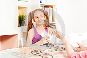 Girl playing cards sitting at the gaming table