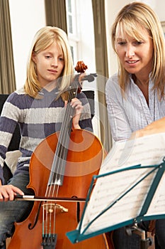 Girl playing cello in music lesson