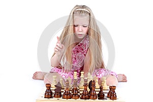 Girl playing chess on white