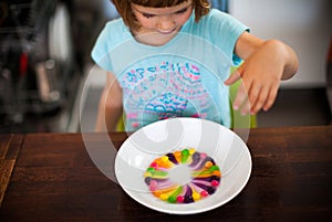 Girl playing with colorful candy photo