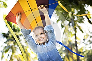 Girl playing with a colorful kite