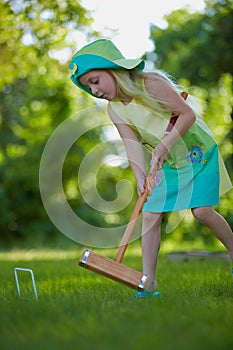 Girl playing croquet