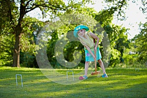 Girl playing croquet