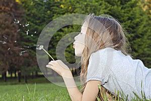 Girl playing with dandelion