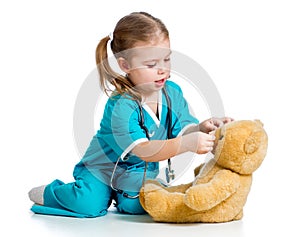 Girl playing doctor and curing plush toy