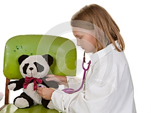 Girl playing doctor with her toys