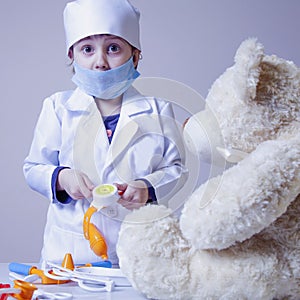 Girl playing doctor and treats teddy bear Health, medicine, hos