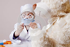 Girl playing doctor and treats teddy bear Health, medicine, hos
