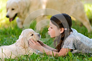 Girl playing with dog`s neb photo