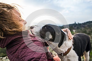 Girl playing with a dog while traveling