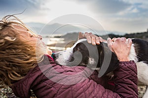 Girl playing with a dog while traveling