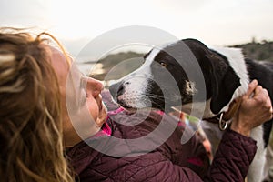 Girl playing with a dog while traveling