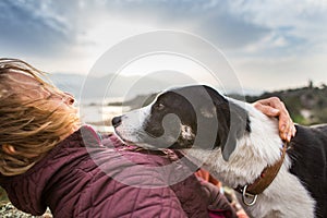 Girl playing with a dog while traveling