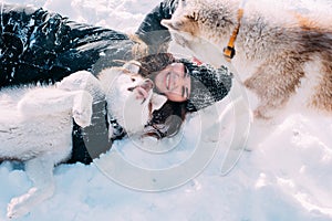 Girl playing with dogs in snow