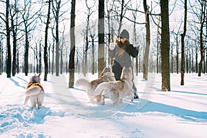 Girl playing with dogs in snow