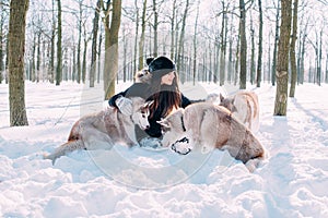 Girl playing with dogs in snow