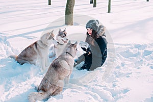 Girl playing with dogs in snow