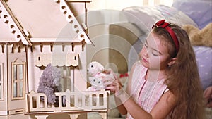 Girl playing with a doll-house