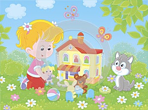 Girl playing with a doll and a toy house