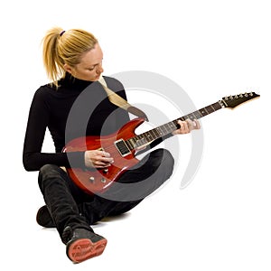 Girl playing an electric guitar sitting down