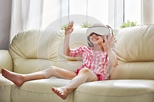 Girl playing game in virtual reality glasses