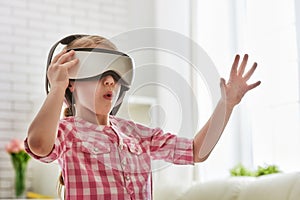 Girl playing game in virtual reality glasses