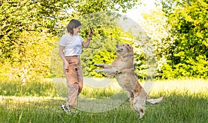 Girl playing with golden retriever dog