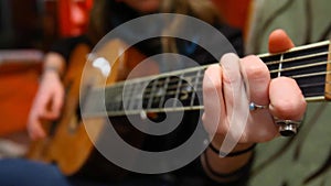 Girl playing guitar in living room