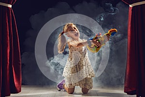 Girl playing guitar on stage